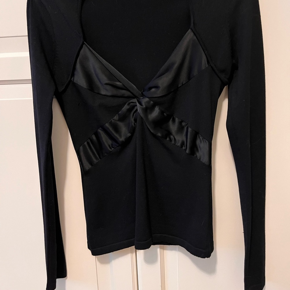 Light weight sweater with satin ribbon over chest, low cut and form fitting.